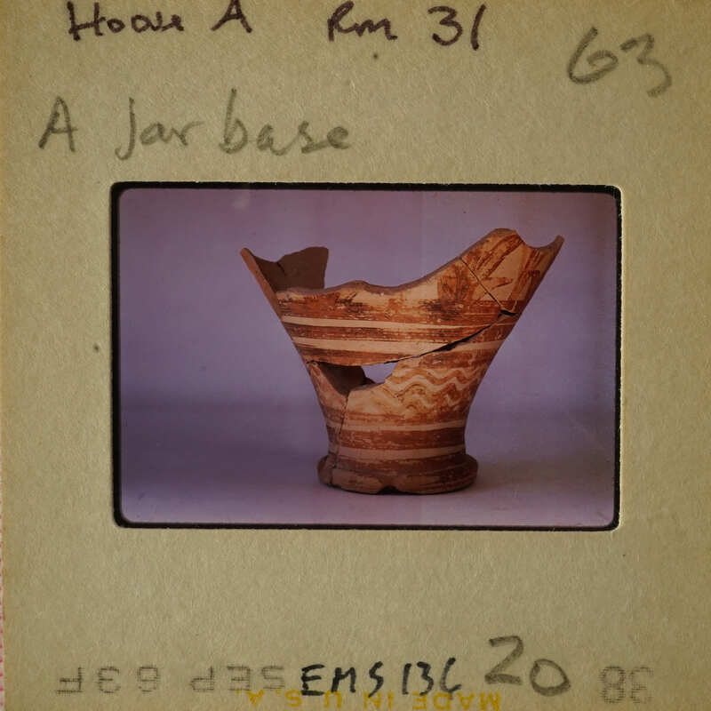 A broken ancient Greek vase with visible patterns and colors.