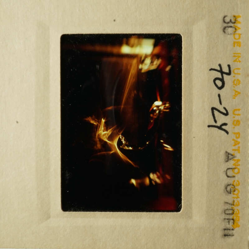 A vintage photograph showing a close-up view of a blurry object with a dark background.