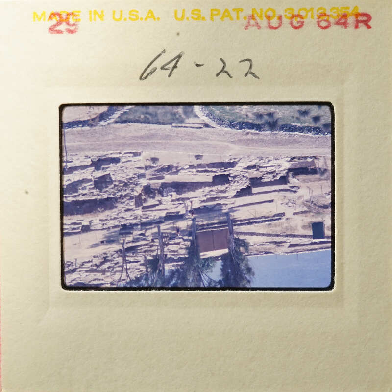 Old photograph of an archaeological site with ruins and excavated areas.