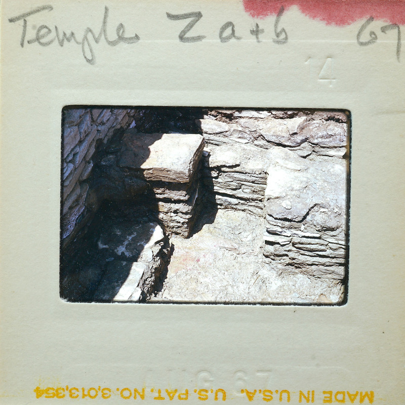 A faded photograph of an old stone structure, possibly ruins or a historical site.