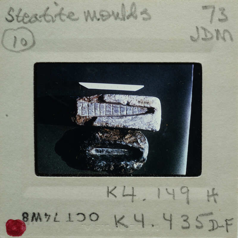 Old, rusted metal object on display with a label and description.