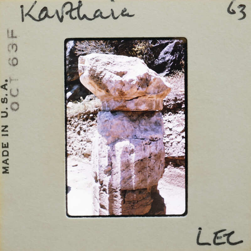 Ancient stone column drum with a weathered surface.