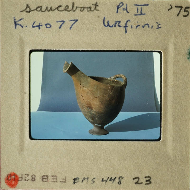 Old vase on display with label and numbering.