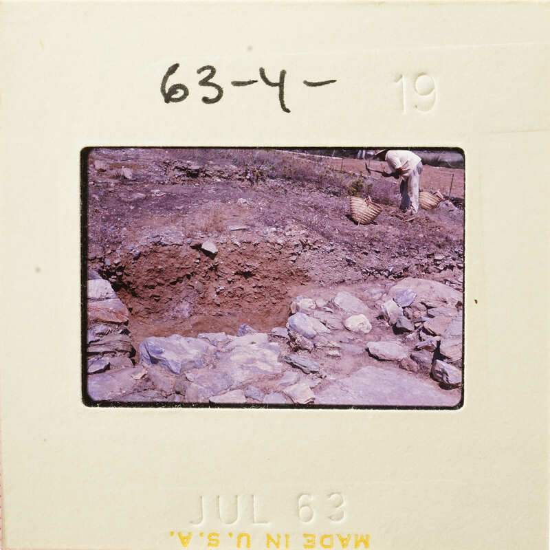 A photograph showing an excavation site with dirt and rocks, possibly from an archaeological dig.