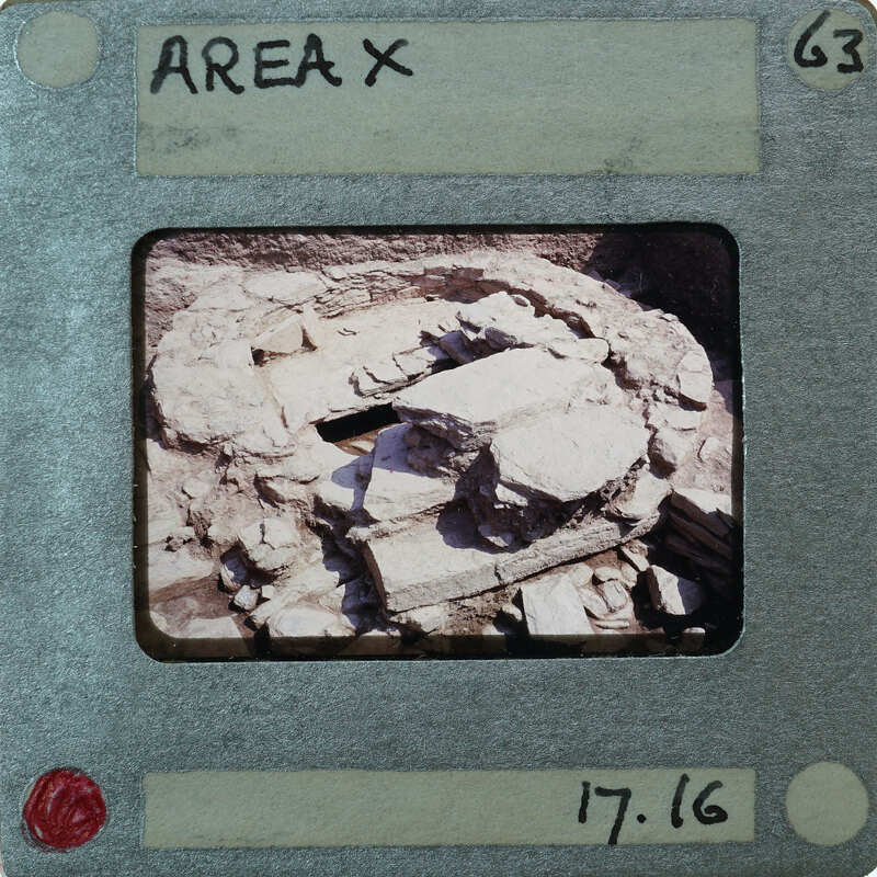Photo of a stone structure with an "Area X" label, dated 17/16.