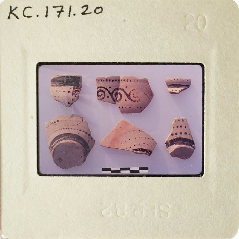 A collection of ancient pottery shards on display.