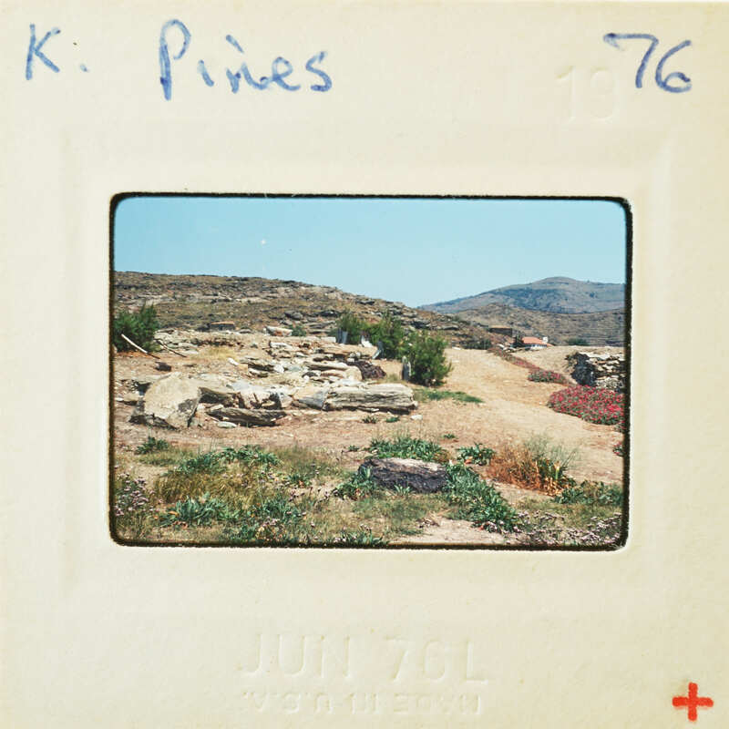 Old photo of a desert landscape with rocky ruins and sparse vegetation, taken on June 7th, 1976.