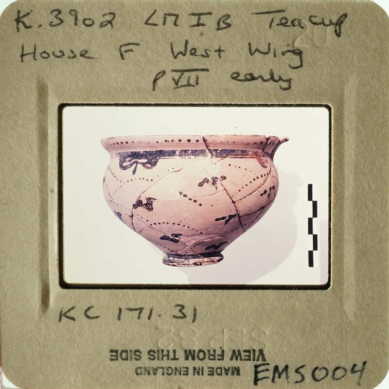 Ancient Greek vase with black and red figures on display.