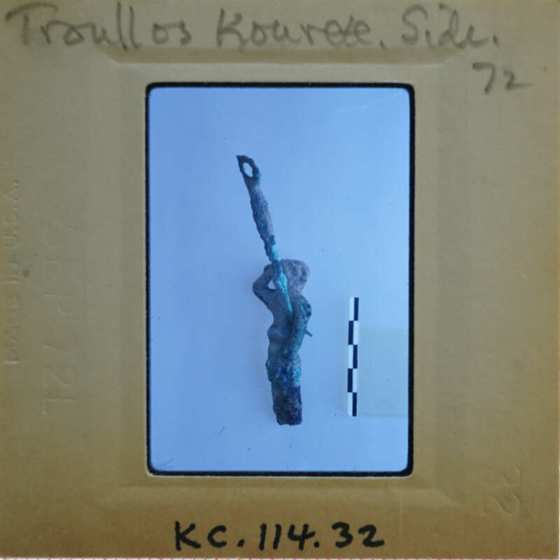 Small, greenish-brown figurine with a spear on a white background.