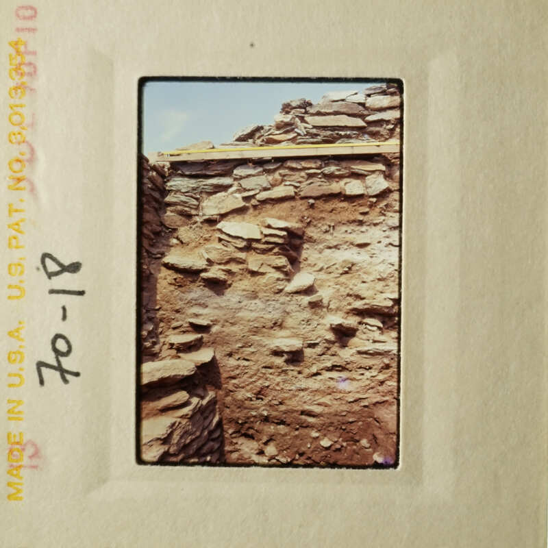 An aged photograph of an old stone building.