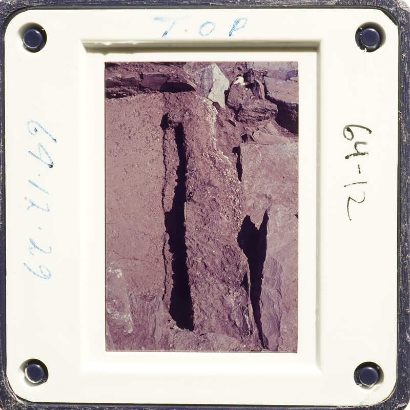 This is an image of a rock with a hole, captured on a film strip.