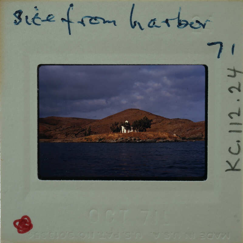 This is a photograph of a scenic harbor with a small island and buildings, taken on October 7th, 1962.