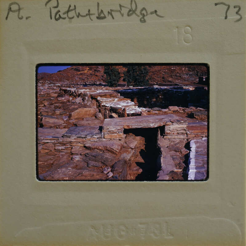 An old photo of a stone bridge with numbers and writing on the border.