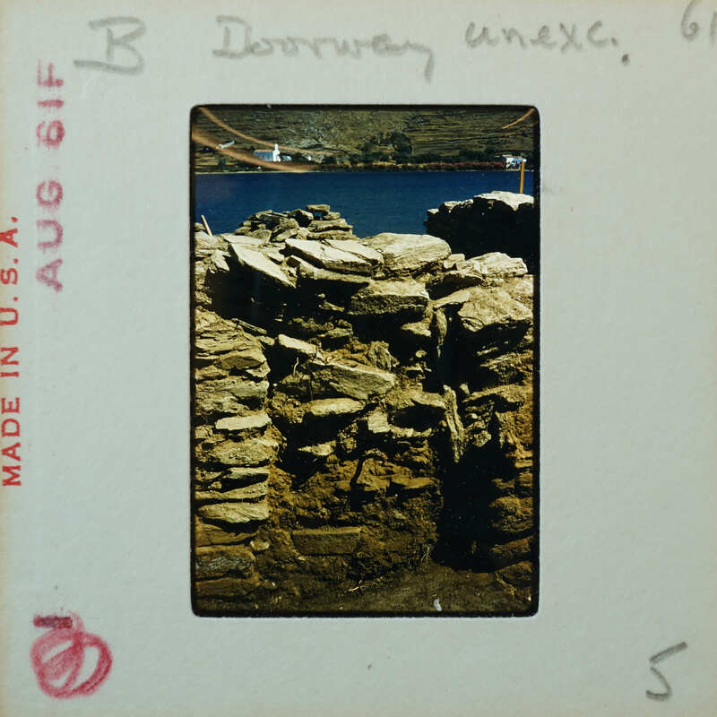 Detail of stone wall with doorway filled with similar stones.
