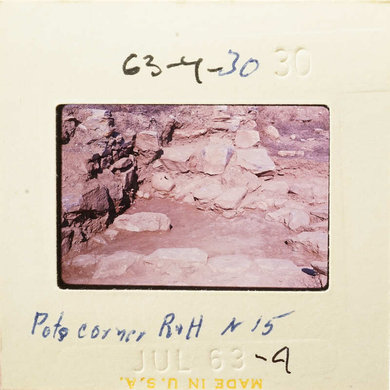 This is an old photograph showing a rocky cave-like structure with handwritten notes on its border.