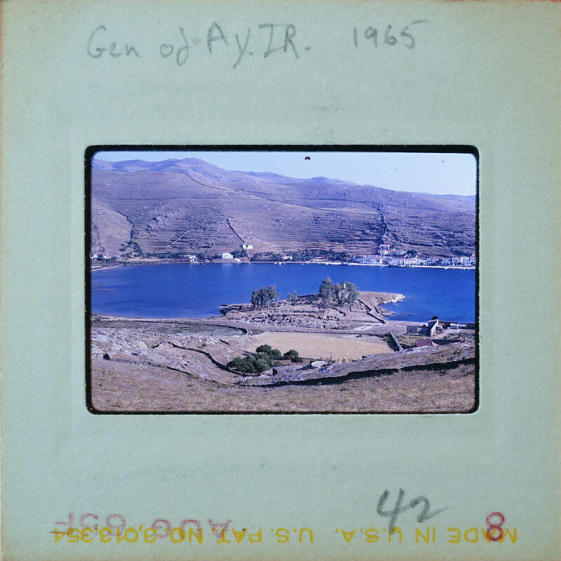 A coastal landscape with a body of water and mountains in the background.