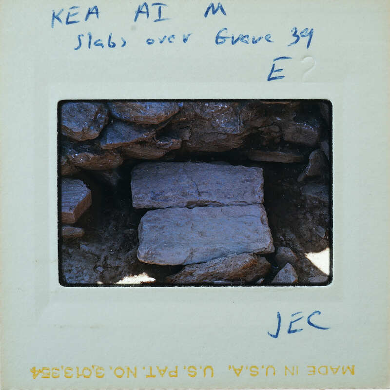 A close-up photograph of a rock formation with handwritten notes on the border.