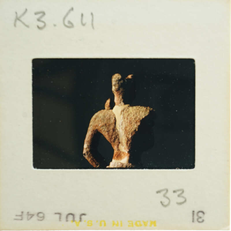 Torso and head of terracotta figurine from the back.