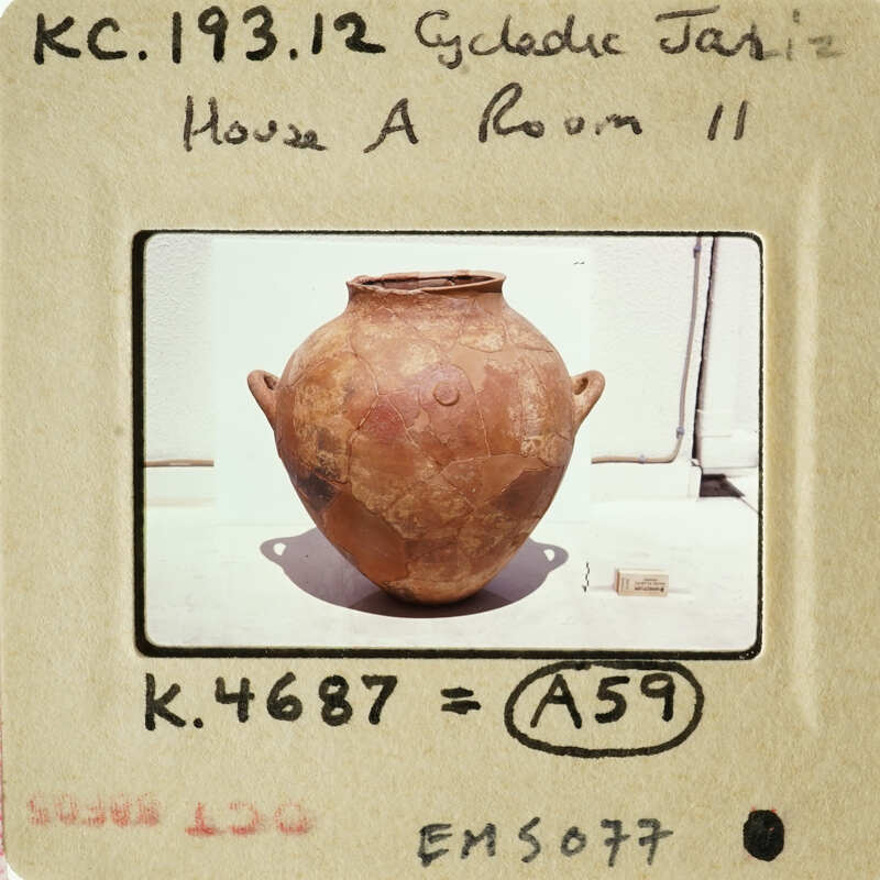 Old clay vase with worn surface on display.