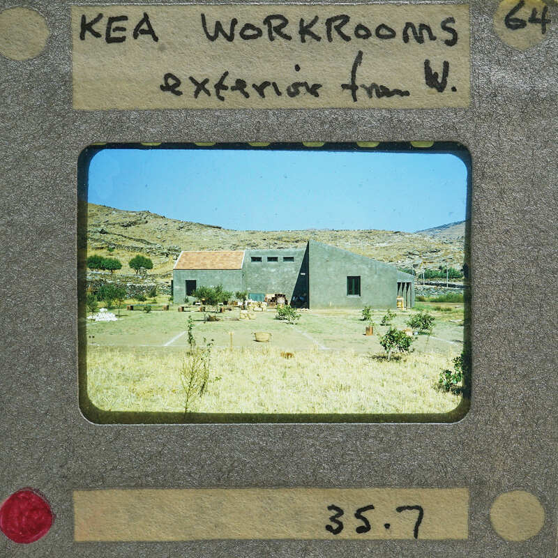A vintage film strip showing a building with a mountainous background.