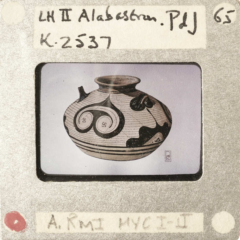 A black and white image of a vase with an intricate design on it.