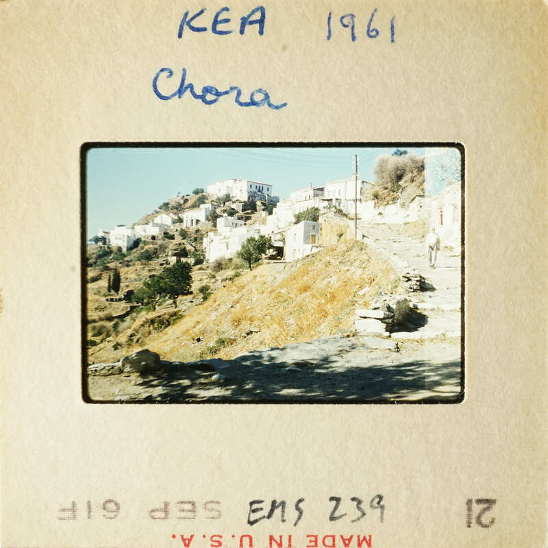 A photograph of a village with houses and trees on a hillside, taken in 1961.