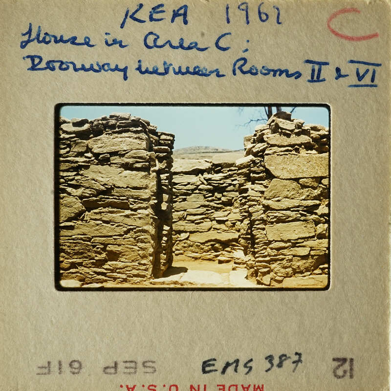 Ancient stone ruins with open doorways and walls.