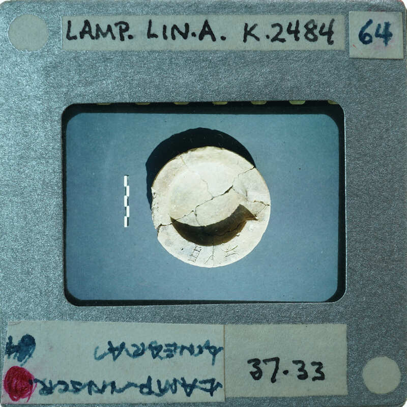 Reassembled bowl of lamp from top showing letters carved in rim, K.2484.
