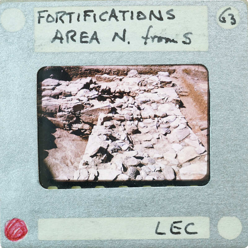 This is a vintage photograph of an archaeological site with stone ruins, labeled as "Fortifications Area N" and bearing the number "63."
