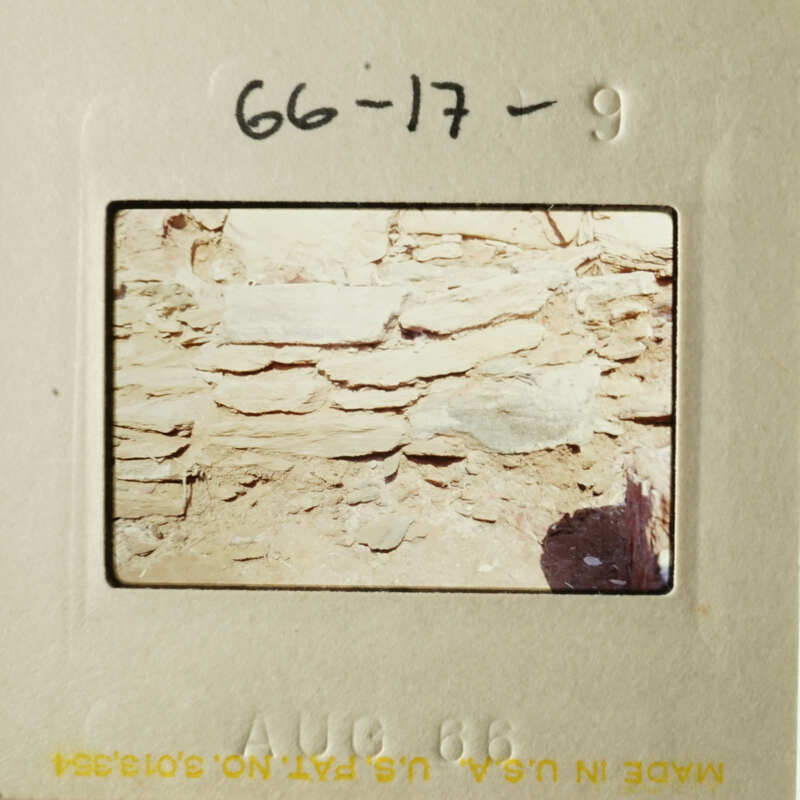 A faded photograph depicting an ancient stone wall.