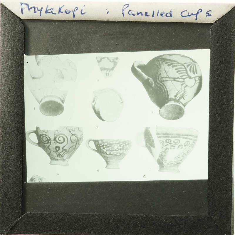 A framed collection of antique cups and saucers with various designs.