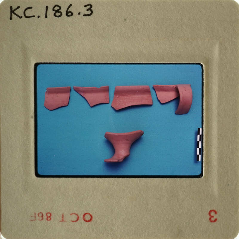 Old photograph with red clay pieces on blue background.