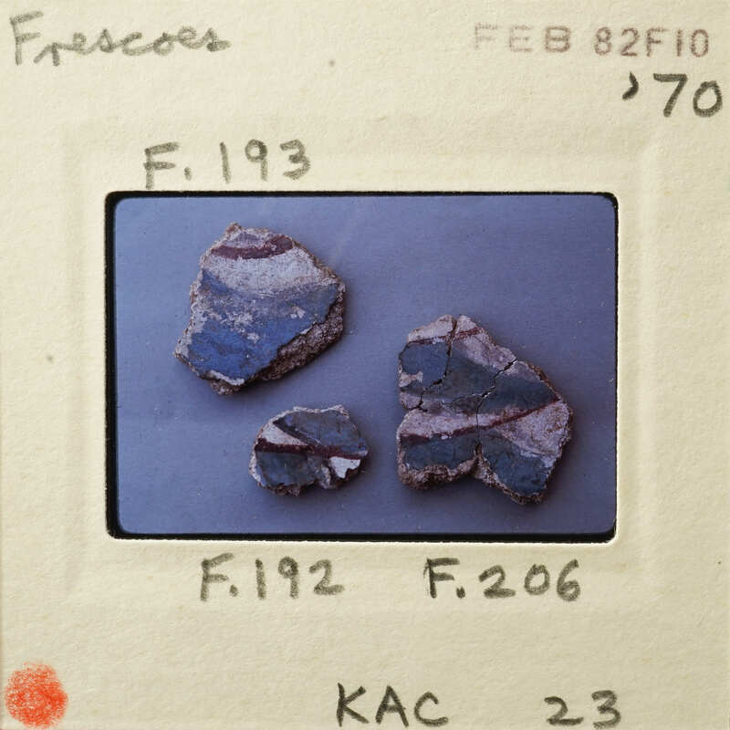 Three broken pieces of blue and white ceramic on a surface.