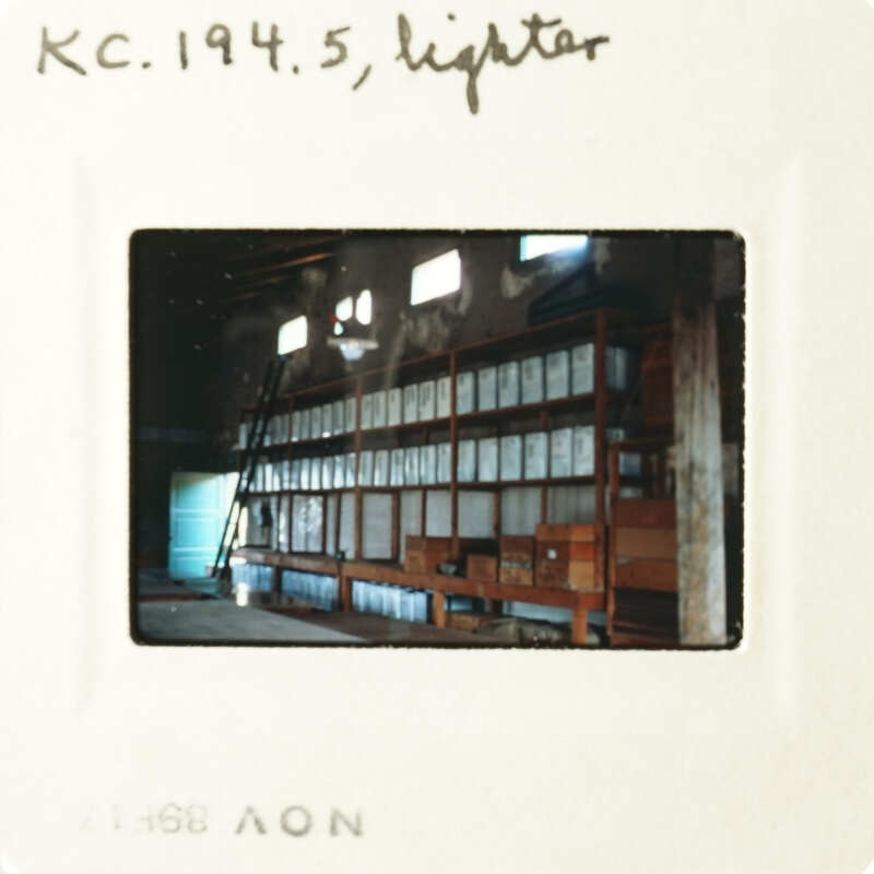 A photograph of an empty room with shelves and a window.