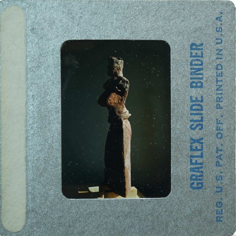 Detail of almost complete terracotta figurine from the side minus right arm.