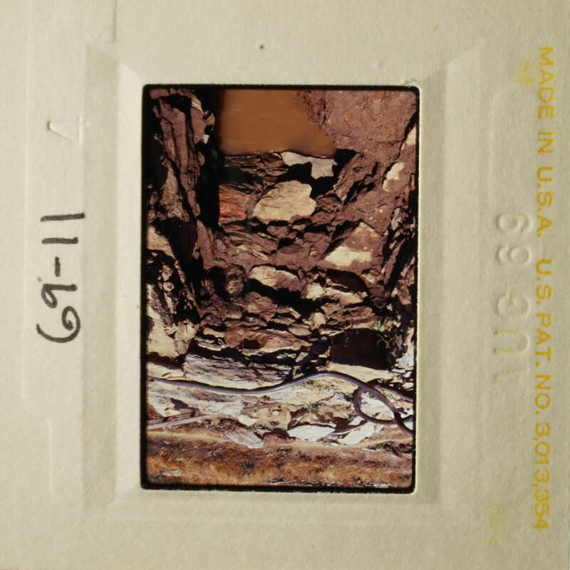 A photograph of a rocky cave interior with a watermark indicating it's made in the USA.