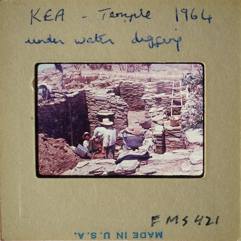 Archaeological site with workers excavating under water.