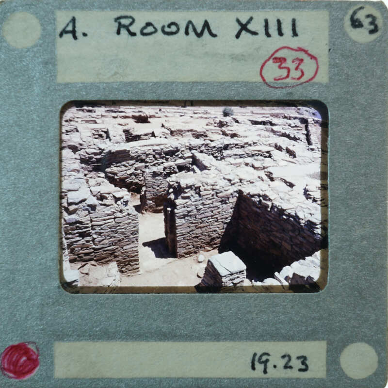 Photo of an old stone structure with a room number and date stamp on it.
