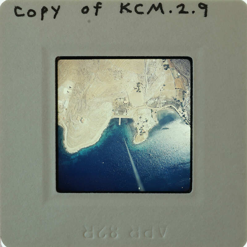 Aerial photograph of a coastal landscape with water and land features.