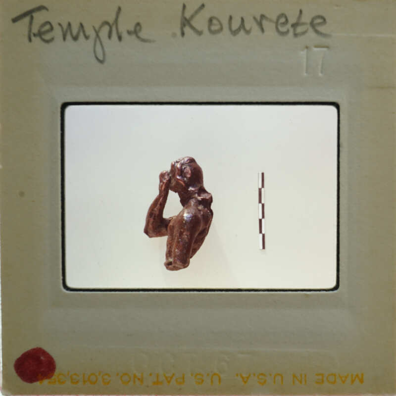 A photograph of a figurine on film negatives.