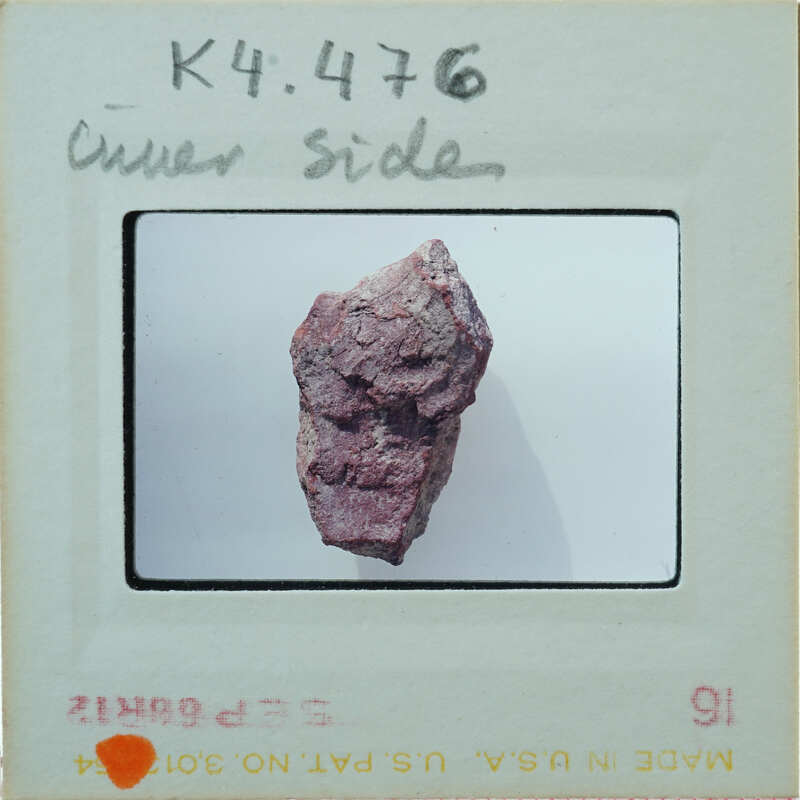 A photograph of a rock with a face-like formation on it.