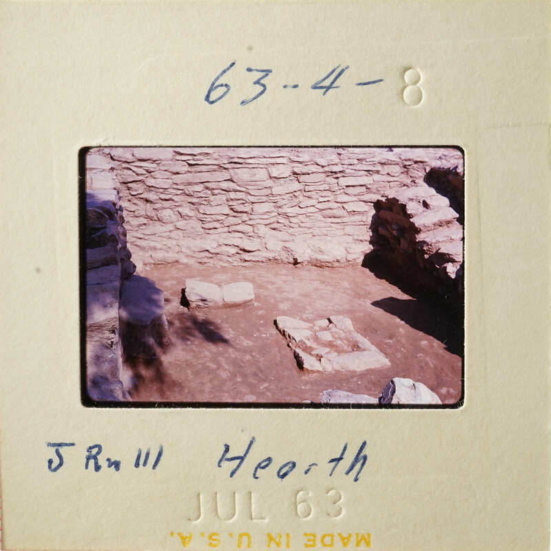 Old stone ruins with vegetation, captured on a vintage film strip.