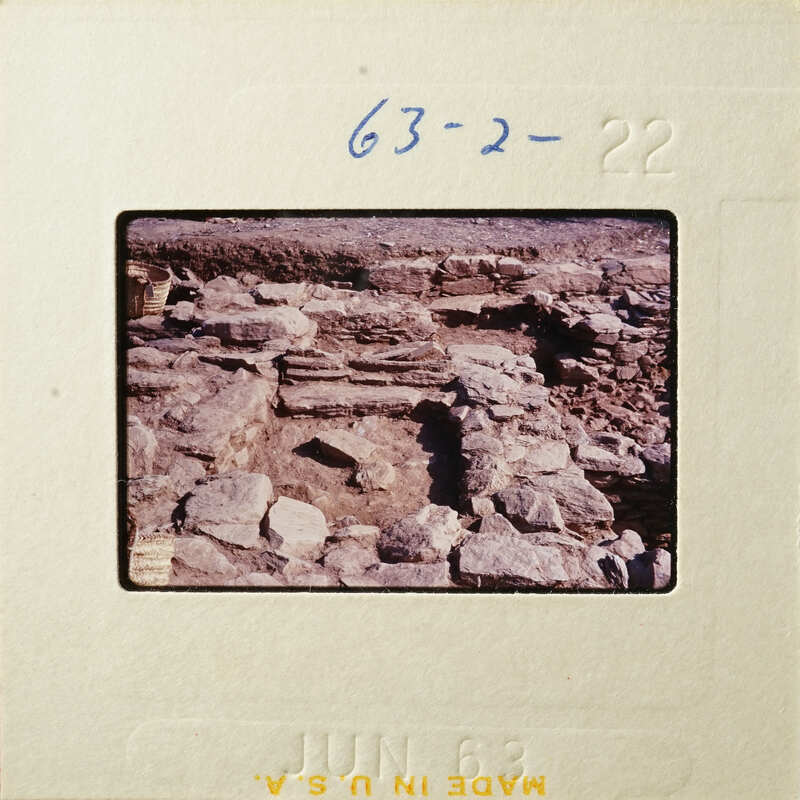 Old stone ruins with vegetation, captured on an antique photographic film strip.