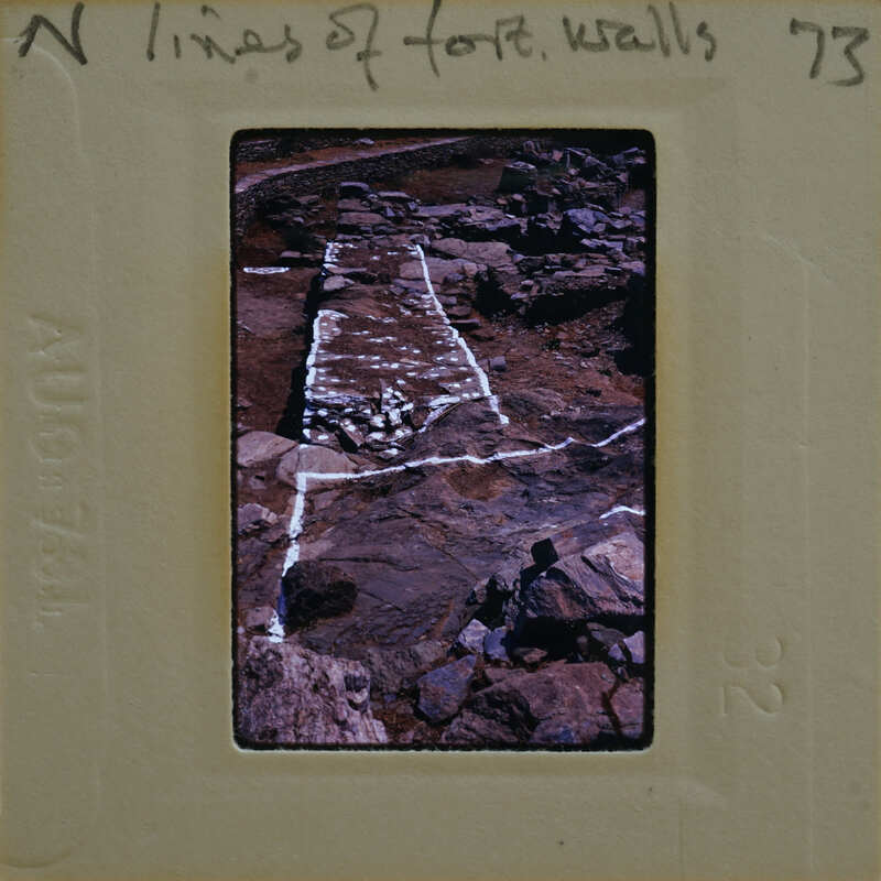 Photo of a rocky cliff with white markings, possibly for climbing or scientific study.