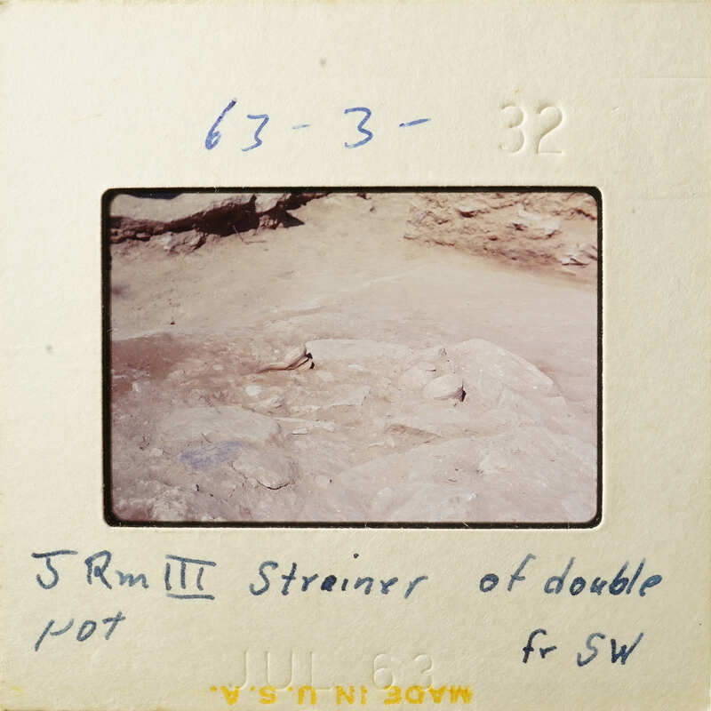 A photograph of an ancient rock surface with markings, possibly from an archaeological site.