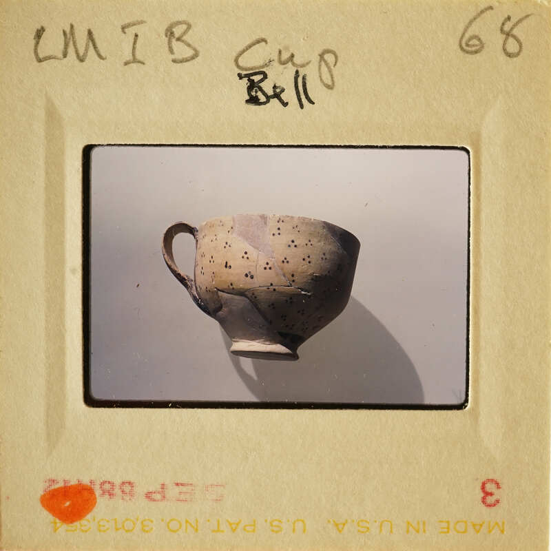 Ancient clay pot with dark brown spots.