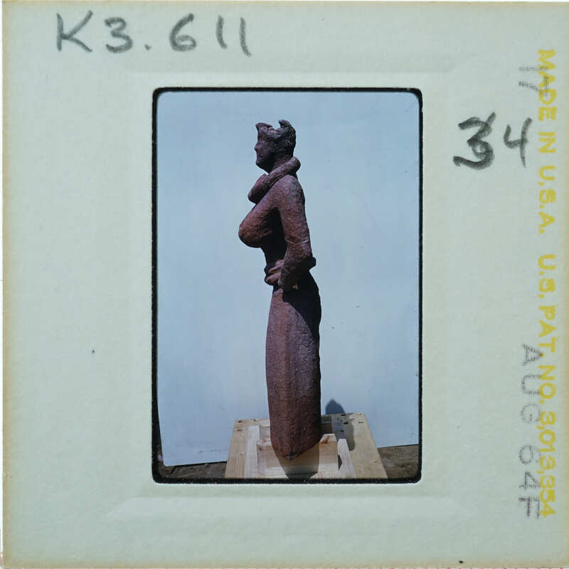 Detail of almost complete terracotta figurine from the side minus right arm.