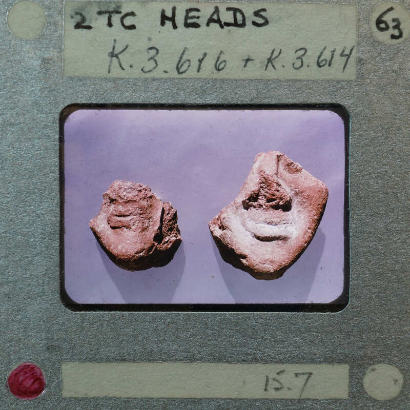 Two terracotta figurine face fragments from front showing chins and lips K3.616, K3.614.
