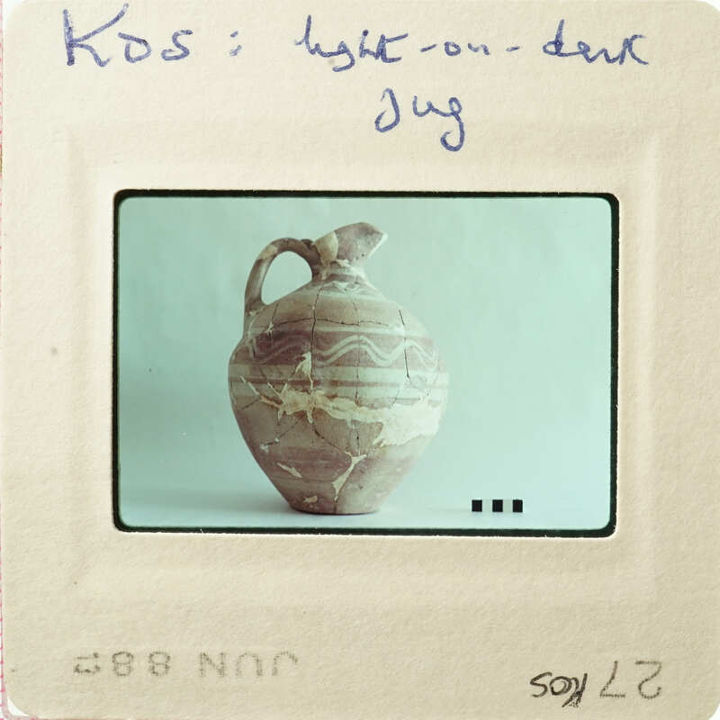 Ancient clay vase with patterned design on display.