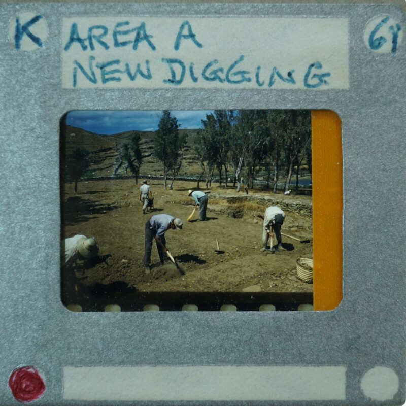 A vintage photograph of men working on a field, with an overlaid label indicating it's from a new digging area.